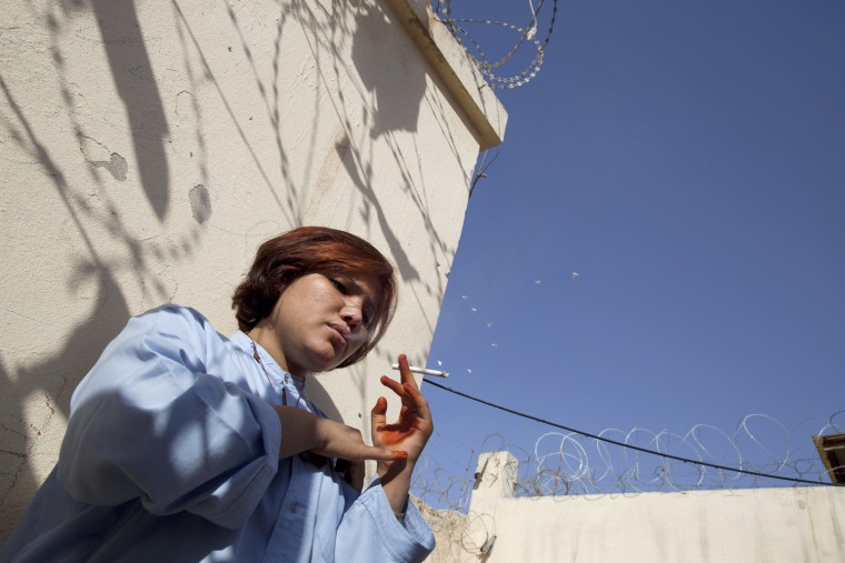 Shawal Jamila,19, smokes a cigarette inside the women's prison Oct. 2010 in Mazar-e-Sharif, Afghanistan. She ran away from home with her boyfriend and for that she's been in prison for five months. Many of the females that are incarcerated are being detained for