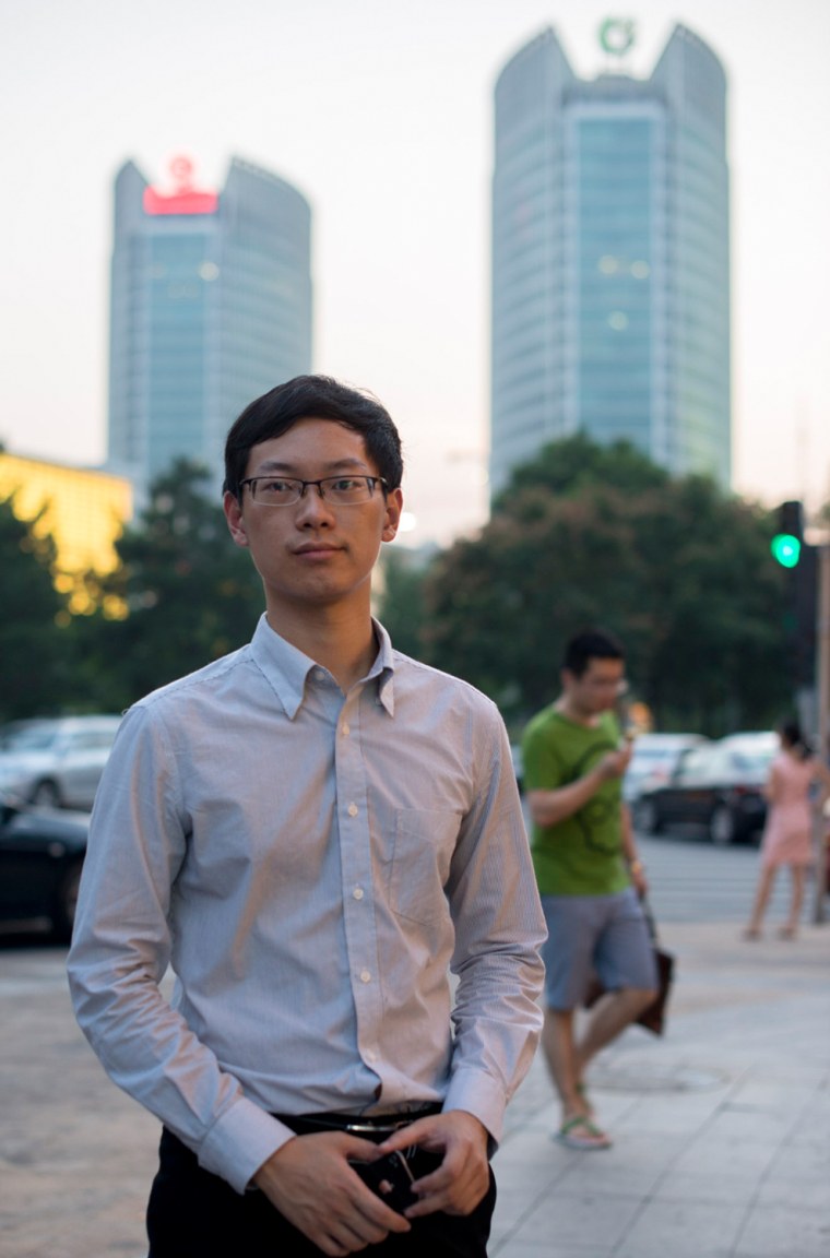 David Ni takes a break from work in Beijing's financial district, Aug. 9, 2013.