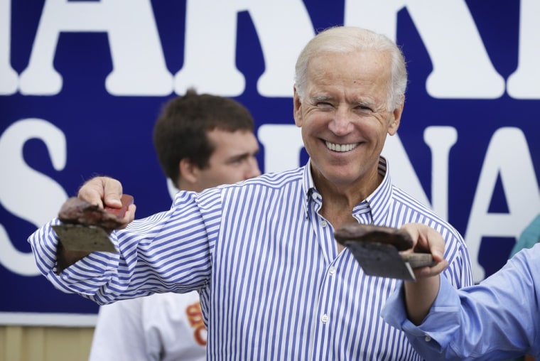 Joe Biden picks up a steak off the grill during Iowa Sen. Tom Harkin's annual fundraising steak fry dinner in Indianola on Sunday.