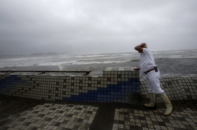 A man looks at turbulent ocean waves at Enoshima in Fujisawa, near Tokyo, on Sept. 16, 2013. Powerful typhoon Man-yi bore down on Japan and went past Tokyo on Monday.