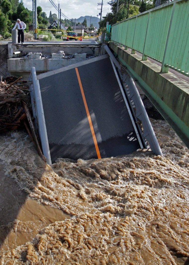 A bridge that collapsed into a flooded river in Kyoto as torrential rain hit western Japan.