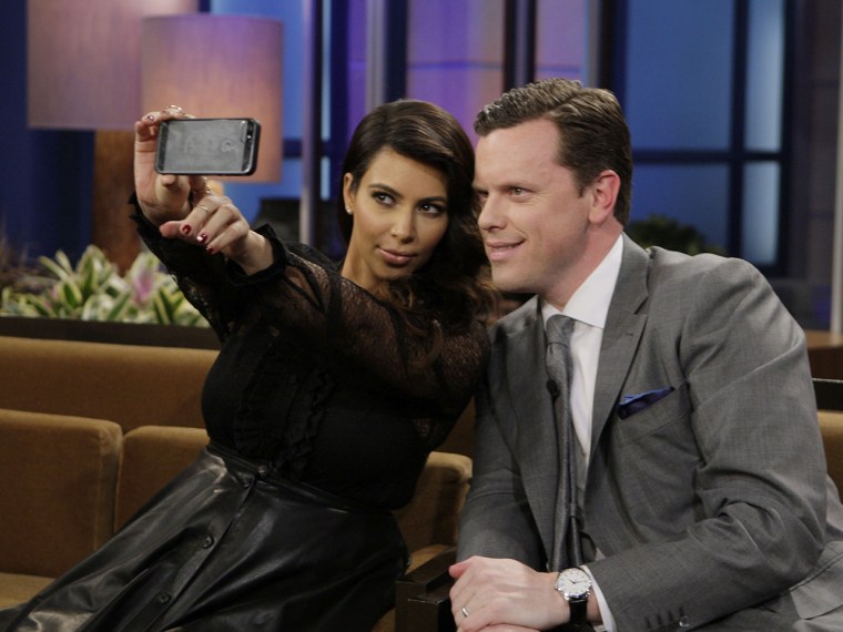 Kim Kardashian uses her iPhone to take a photo with TODAY's Willie Geist on the set of \"The Tonight Show with Jay Leno.\"