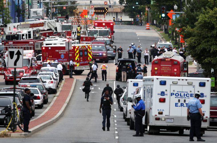 WASHINGTON, DC - SEPTEMBER 16: Emergency vehicles and law enforcement personnel respond to a reported shooting at an entrance to the Washington Navy Yard September 16, 2013 in Washington, DC. According to the latest news report, several people were shot with the shooter still possibly active.