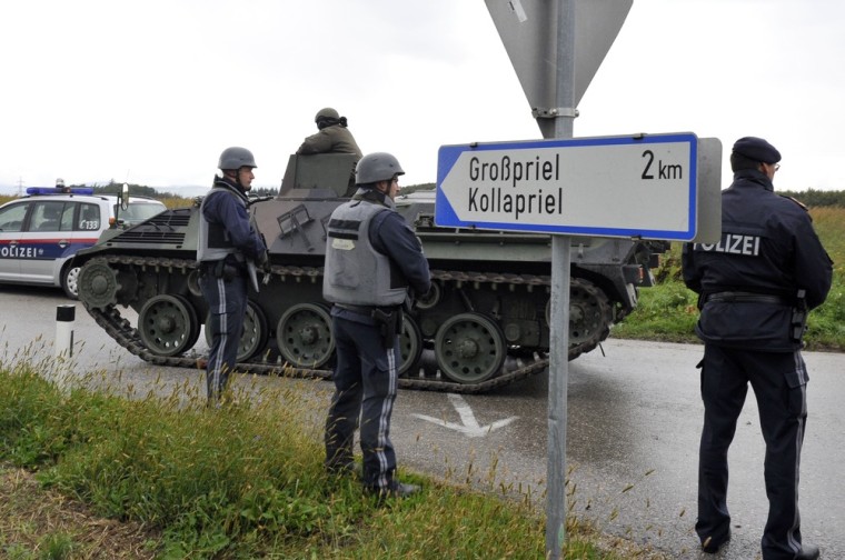Austrian army soldiers in an armored vehicle arrive near the villages of Grosspriel and Kollapriel, in Austria, Tuesday.