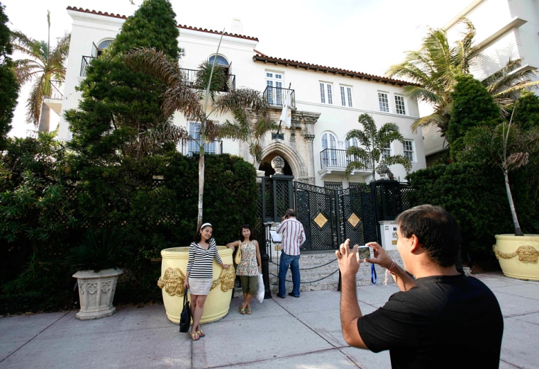 Tourists pose for photos outside of Casa Casuarina, the former home of Italian fashion designer Gianni Versace in Miami Beach, Fla. is shown on Tuesda...