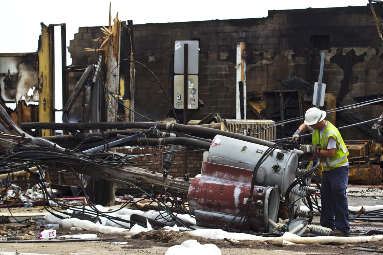 A Jersey Central power and light worker dismantles a transformer after a massive fire in Seaside Park, N.J. on Sept 13. Two New Jersey beach towns devastated by Superstorm Sandy will once again need to rebuild, after a fast-moving fire reduced dozens of businesses along the towns' boardwalk to rubble.