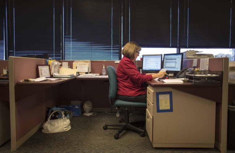 \"I have basically been making the same salary since 2006,\" says Jill Fulk, seen here at her job as a customer service representitive at an insurance c...