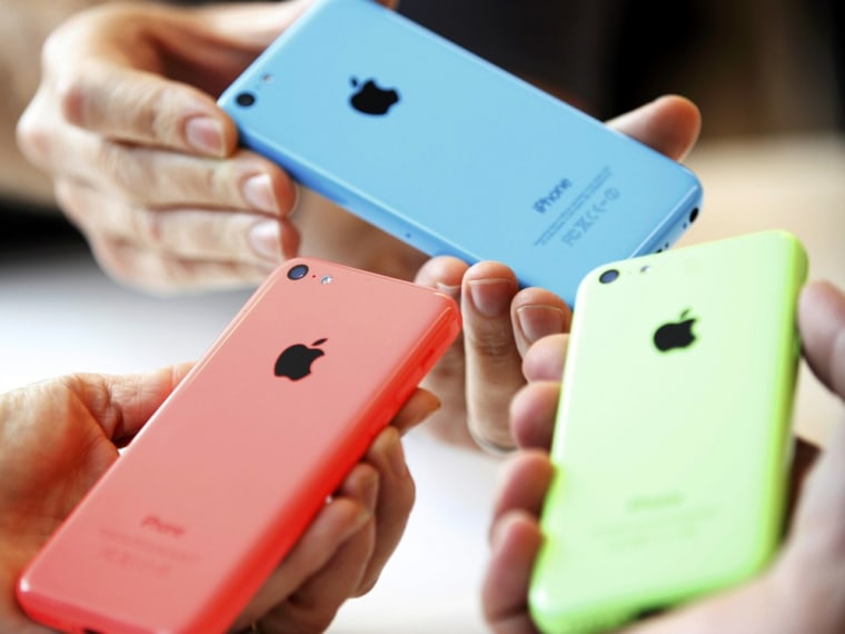 People check out several versions of the new iPhone 5C after Apple Inc's media event in Cupertino, California September 10, 2013. REUTERS/Stephen Lam ...