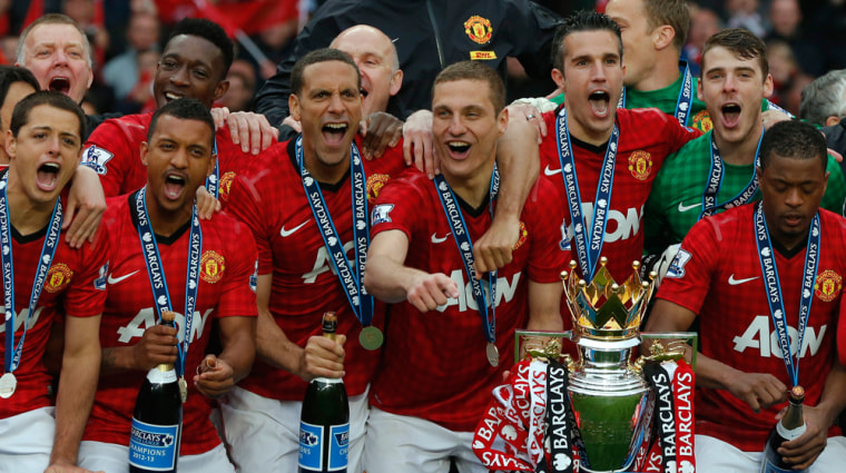 Manchester United players celebrate with the English Premier League trophy at Old Trafford stadium in Manchester, northern England May 12, 2013. Alex ...