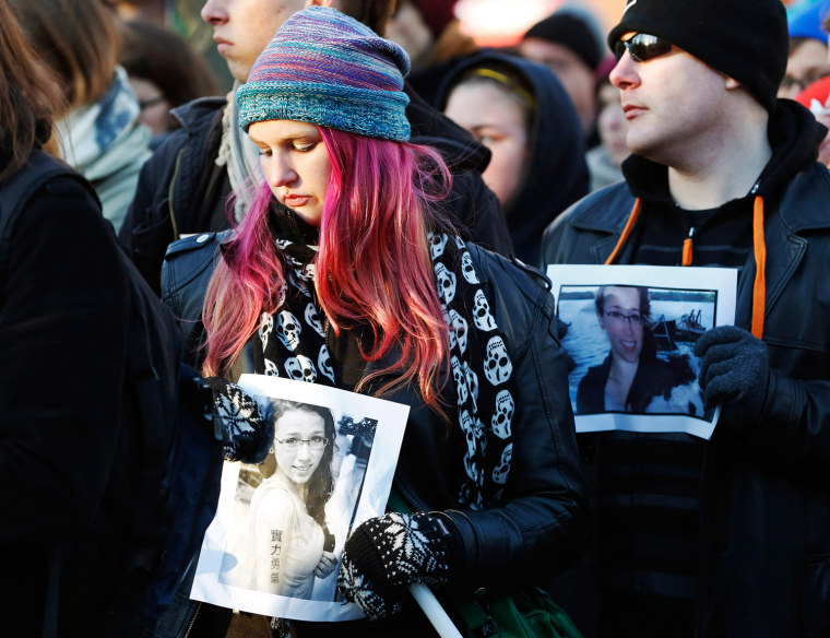 People hold photographs of 17-year-old Rehtaeh Parsons during a memorial vigil at Victoria Park in Halifax, Nova Scotia April 11, 2013. Parsons died o...