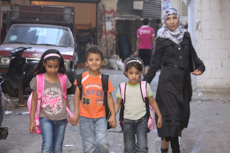Mother walks her children home from the U.N. sponsored school they attend in the Palestinian refugee camp of Shatila, in Beirut's southern suburbs.