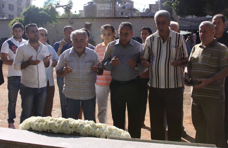 A delegation of Palestinian Liberation Organization members pray at the mass grave on the 31st anniversary of the Sabra- Shatila massacre.