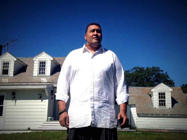 Former NFL lineman Brian Holloway stands outside the New York vacation home trashed by partygoers who invaded his home.