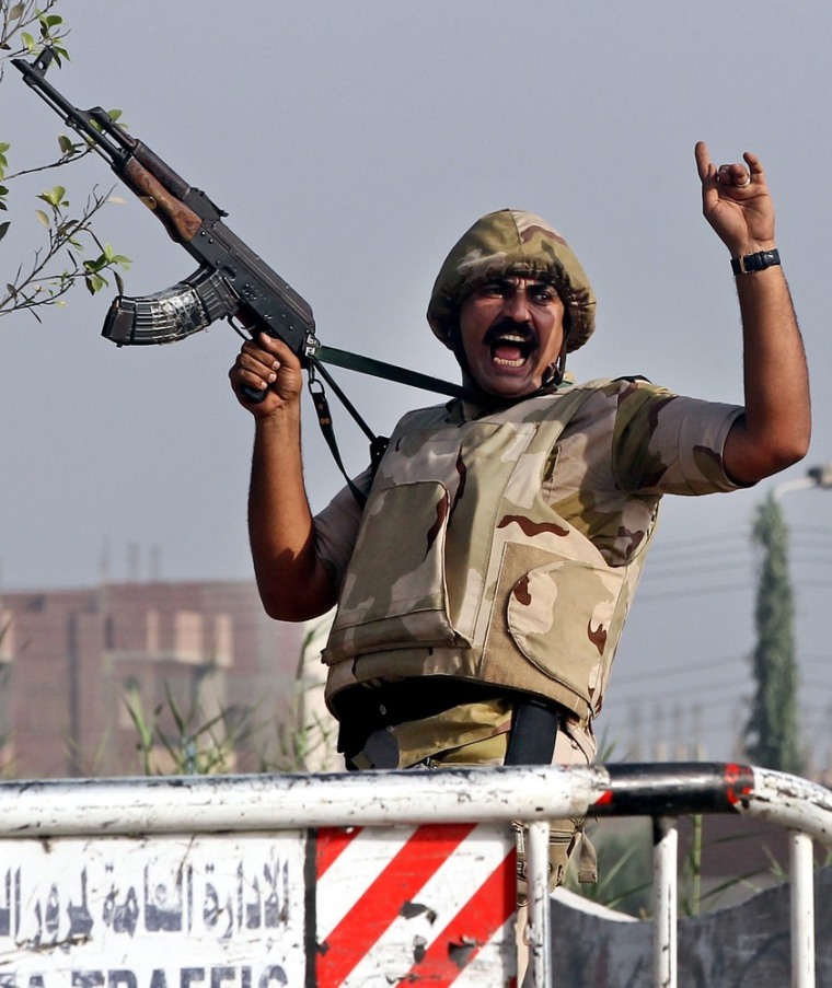 A soldier shouts orders during an operation against gunmen in the Kerdasa district.
