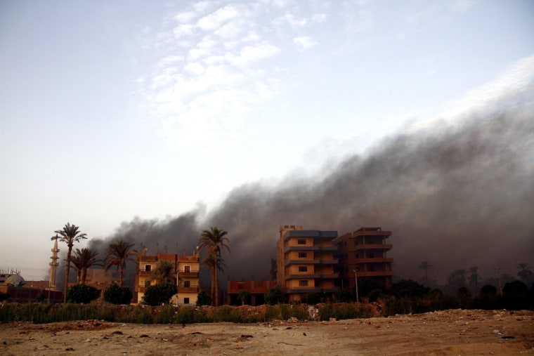 Smoke rises during clashes between Egyptian security forces and suspected militants in the town of Kerdasa.