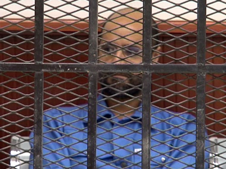Saif al-Islam, son of Libya's late dictator Moammar Gadhafi, looks on in the accused cell as he stands trial in May, in Libya's northwestern town of Zintan.