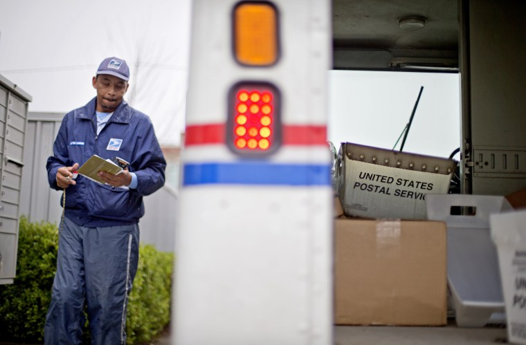 A empty mail bin sits in the back of a truck as U.S. Postal Service letter carrier of 19 years, Michael McDonald, delivers mail, Thursday, Feb. 7, 201...