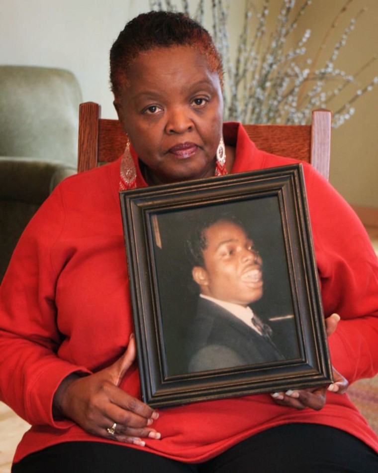 Mary holding portrait of her son, Laramiun Byrd