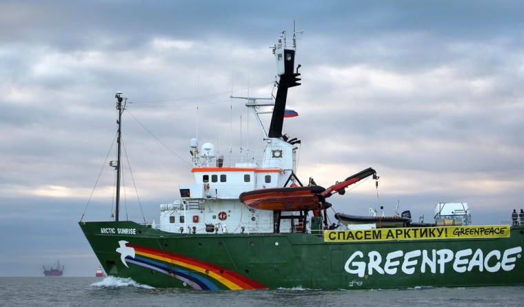A handout photo taken by Greenpeace on September 17, 2013, shows the Arctic Sunrise, Greenpeace's Arctic protest ship, making its way somewhere off Russia north-eastern coast in the Pechora Sea, an arm of the Barents Sea, with Gazproms Prirazlomnaya Arctic oil platform drifting in the background.