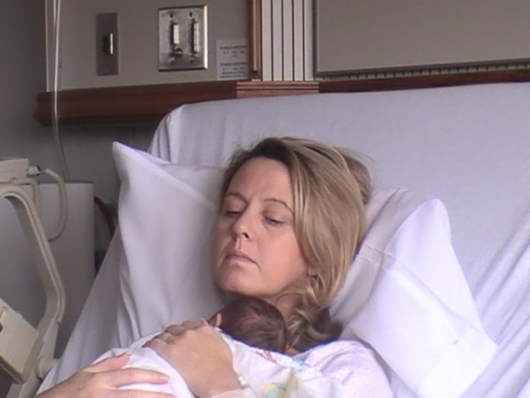 Carolyn Savage holding Logan Morell on the day he was born in 2009.