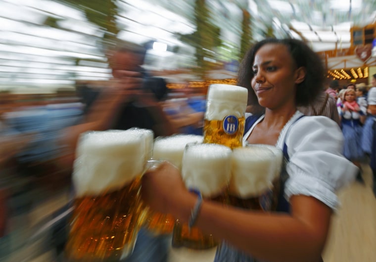A waitress carries mugs of beer during the opening ceremony for Oktoberfest.