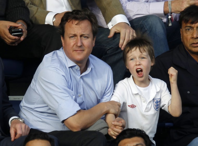 British Prime Minister David Cameron looks on as his son Arthur celebrates a goal at an English Premier League soccer match in 2011.