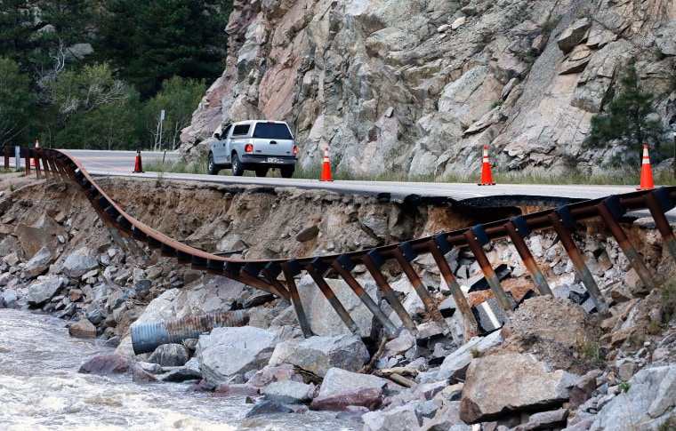 A guardrail hangs away from a closed canyon road, where some local residents are allowed to drive with caution, and which is washed out in places by recent flooding, up Boulder Canyon, west of Boulder, Colo., Friday Sept. 20, 2013.