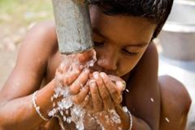 A child drinks water from a WASA run tube well, at a slum in Rayer Bazaar, in Dhaka, Bangladesh.