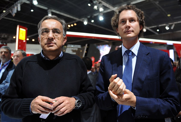 Sergio Marchionne (L), head of carmakers Fiat and Chrysler, and Fiat chairman John Elkann attend a presentation at the Paris Motor Show on September 2...