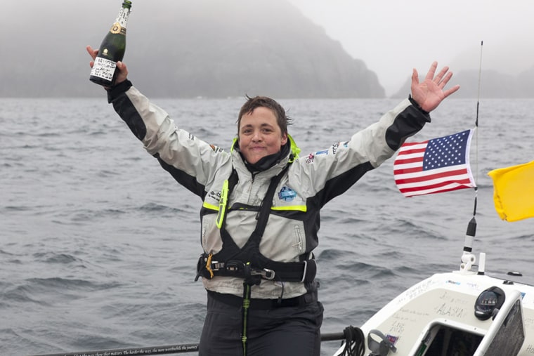 Sarah Outen celebrates after she rowed solo from Japan to Alaska.