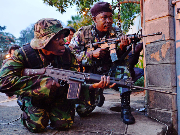 Kenyan soldiers take cover after heavy gunfire near Westgate mall in Nairobi on September 23.