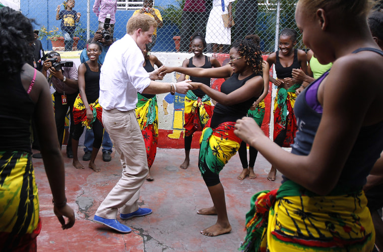 Britain's Prince Harry (L) dances with Chantol Dormer at a youth community center in Kingston, Jamaica March 6, 2012. The Prince is on a week-long tou...