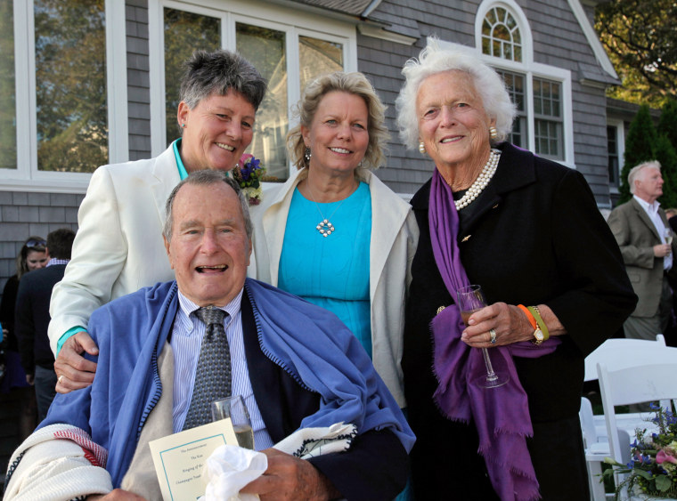 Former President George H.W. Bush and wife Barbara Bush, right, pose for photos after the wedding of longtime friends Helen Thorgalsen, center, and Bonnie Clement, in Kennebunkport, Maine, on Saturday.