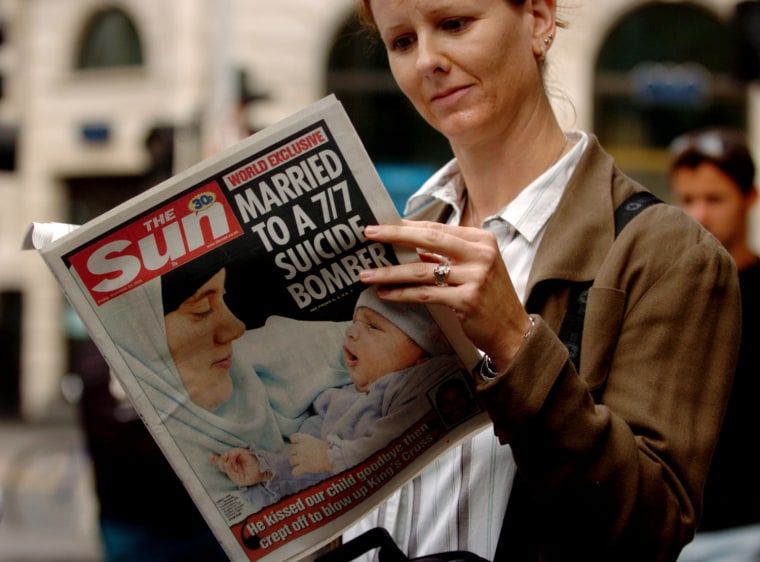 A woman holds a copy of the British tabloid newspaper The Sun on Sept. 23, 2005 with a front page story about Samantha Lewthwaite, wife of suspected London suicide bomber Germaine Linsday.