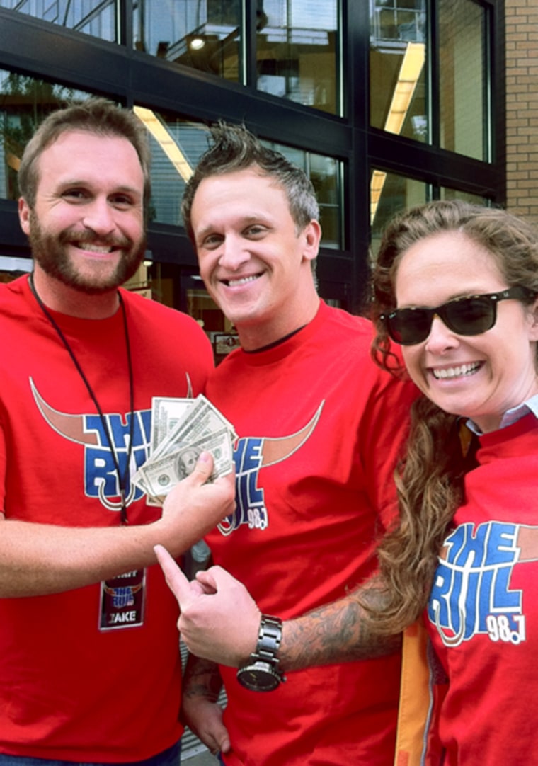 Oregon's KUPL morning show hosts Jake Byron, Howie Drumond and Monica Lunsford show off cash they plan to hide in groceries throughout the Pacific Northwest.