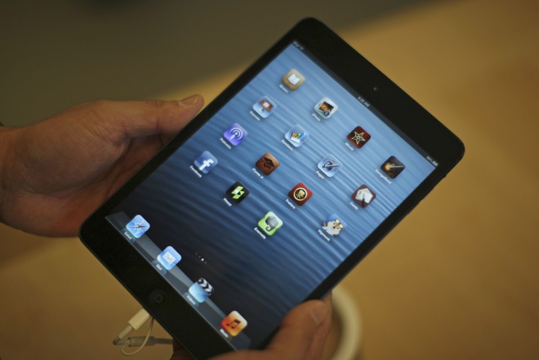 A man holds an iPad mini during the launch of the iPad mini and iPad with Retina display Wi-Fi models in Los Angeles in 2012.