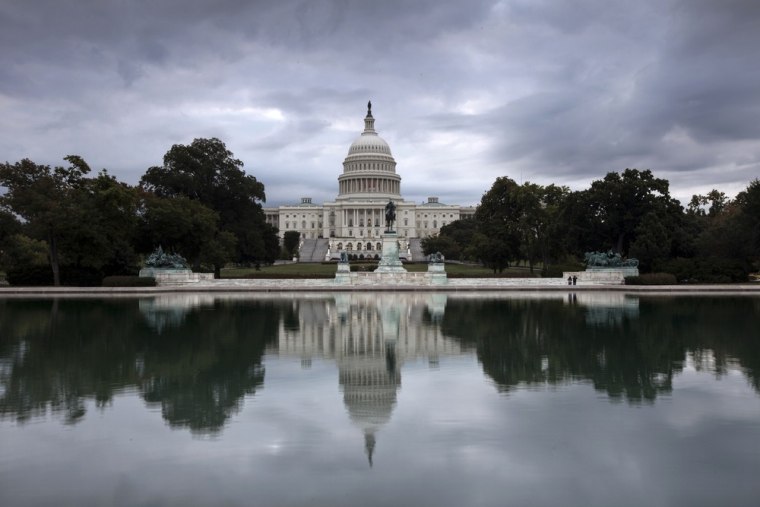 Storm clouds hang over Capitol Hill in Washington, Friday, Sept. 27, 2013, as the Republican-controlled House and the Democrat-controlled Senate stand...