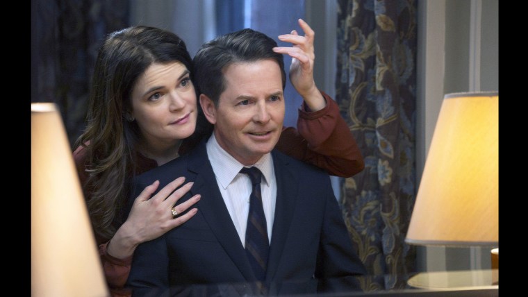 This image released by NBC shows Betsy Brandt as Annie Henry, left, and Michael J. Fox as Mike Henry in \"The Michael J. Fox Show,\" premiering Sept. 26...