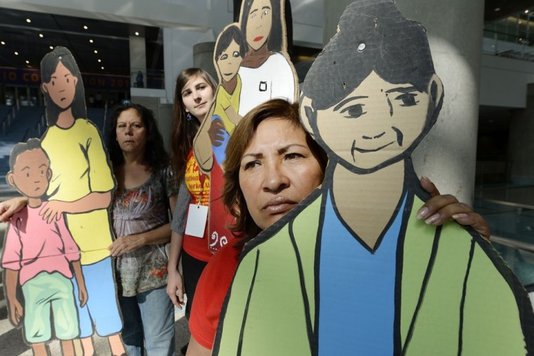 Guillermima Castellamos, a former domestic worker now an organizer for National Domestic Workers Alliance, holds on to a cardboard cutout of a domesti...