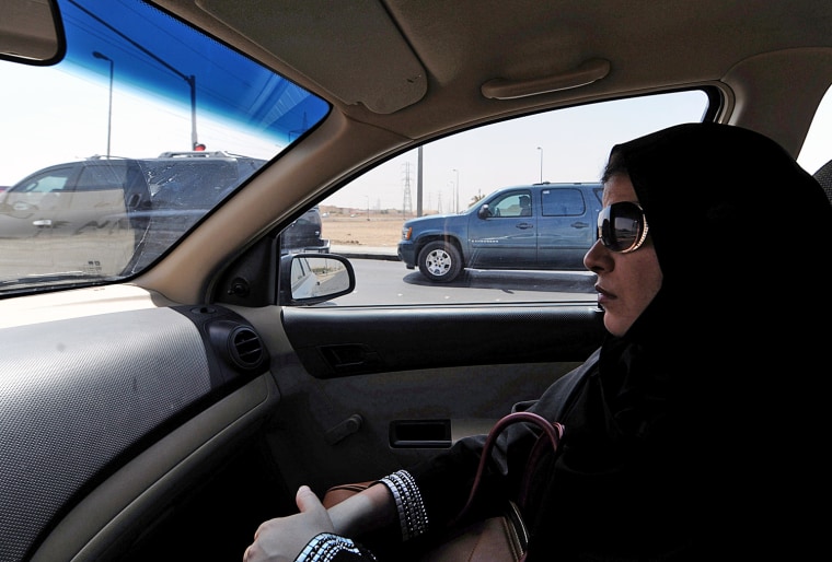 A Saudi woman sits in the passenger seat of a vehicle on Sept. 22 in Riyadh. Saudi women activists have called for a new day of defiance next month of the longstanding ban on women driving in the ultra-conservative kingdom.