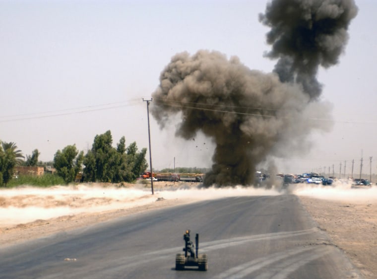 A U.S. Army Talon-3B tracked robot waits for its next command as the 70th Engineers, Explosive Ordnance Team remotely detonate an improvised explosive...