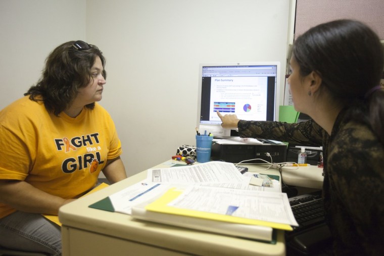 Amy Ball, right, counsels Wanda Perry, 48, left, about possible options for health insurance in Delaware once the new exchanges open on Tuesday. Christiana Care Health System in Wilmington, Del., is providing marketplace