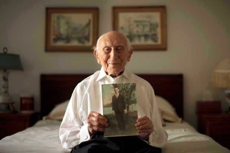 Harry Rosen with a photo of himself from his early 20s. Dining out energizes him, he says.
