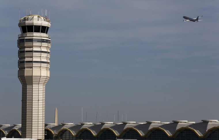 A jet departs Washington's Reagan National Airport next to the control tower outside Washington, in February.