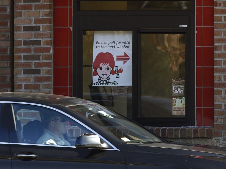 A customer pulls up to the drive thru window at a Wendy's restaurant in Marshfield, Mass., Tuesday, Nov. 8, 2011. Wendy's Co.'s third-quarter loss wid...