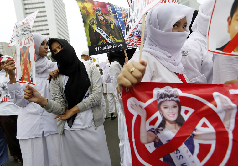 Members of an Indonesian hardline Islamic group hold signs during a protest against the Miss World competition on September 6, 2013 in Jakarta, Indonesia.