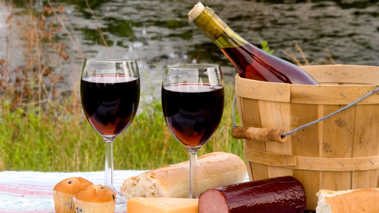 A wine and cheese picnic in the country.