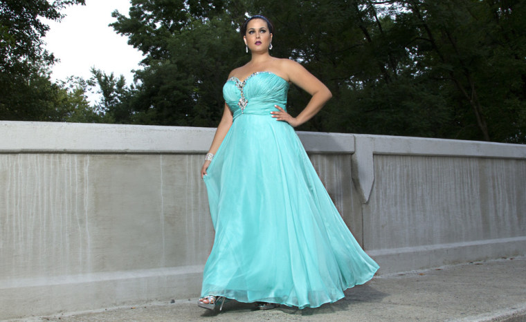 A woman models a plus-size prom dress from Sydney's Closet.