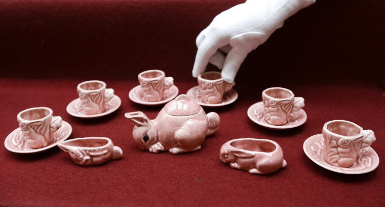 A pink tea set in the shape of a rabbit is displayed at Buckingham Palace in London, Wednesday, April 2, 2014. The tea set, a childhood toy of Britain...