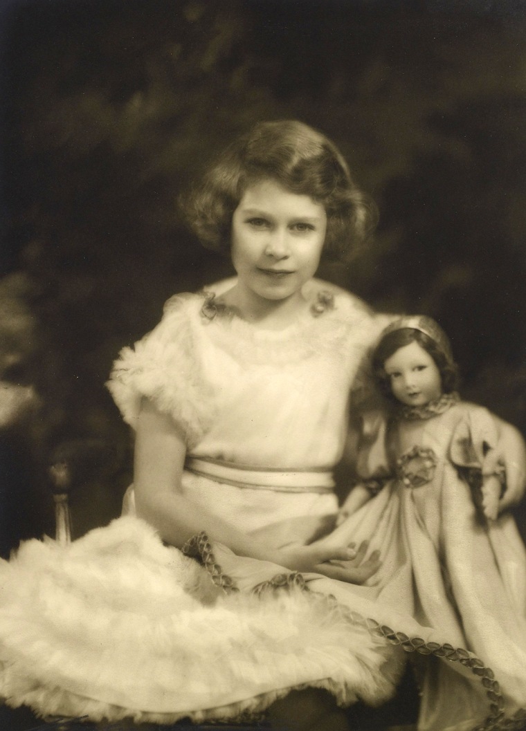 Princess Elizabeth with a Parisian doll, photographed by Marcus Adams. 
<br/>
<br/>Royal Collection Trust / (C) Her Majesty Queen Elizabeth II 2014. 
...